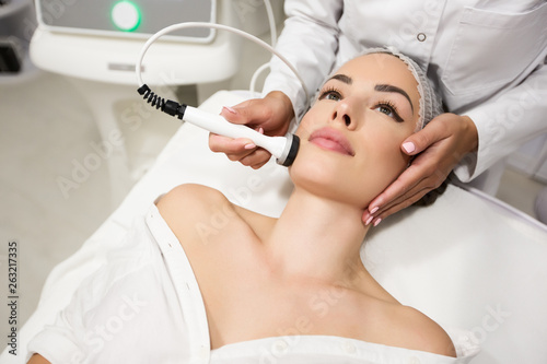 Beautiful woman in professional beauty salon during photo rejuvenation procedure