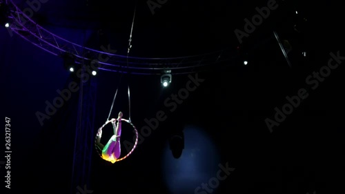 Langhorne, PA / United States - April 18, 2019: Wide circus performer woman hanging from ring close up photo