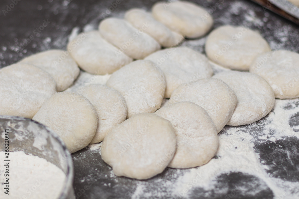 Raw dough on the backery table. Preparing bread dough for backing bread. Food preparing concept Raw dough on the backery table. Preparing bread dough for backing bread. Food preparing concept