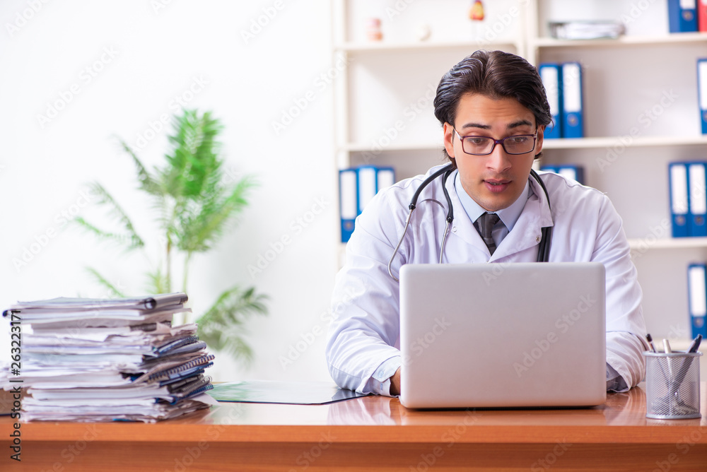 Young handsome doctor working in the clinic Young handsome doctor working in the clinic