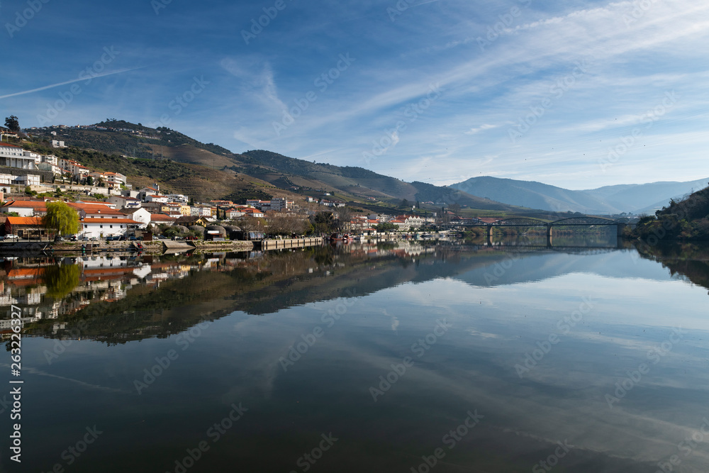 View of the Pinhao village with terraced vineyards and the Douro River, in Portugal; Concept for travel in Portugal and most beautiful places in Portugal