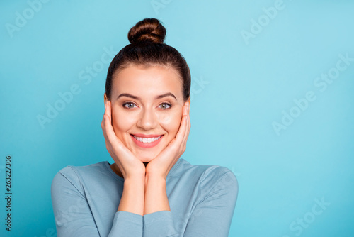 Close up photo of cute charming lady feel content glad rejoice have vacation weekend holidays touch chin face palm hand wear cotton fashionable clothes isolated on blue background