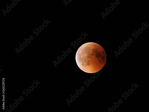 Great Blood Moon during longest total Lunar Eclipse of XXI century on black sky from Poland in 2018 Friday July 27
