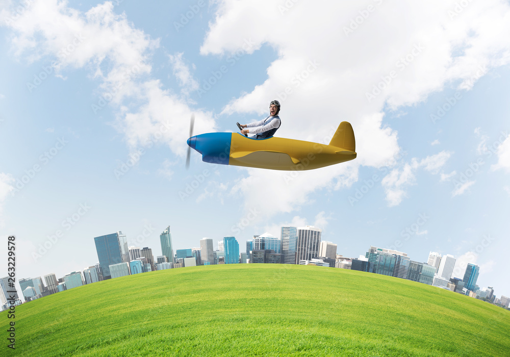 Screaming businessman in leather helmet flying Screaming businessman in leather helmet flying