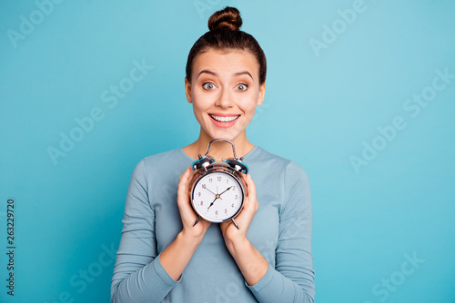 Close-up portrait of her she nice-looking attractive winsome lovely cheerful cheery funny girl holding in hands retro vintage clock isolated over bright vivid shine turquoise background photo