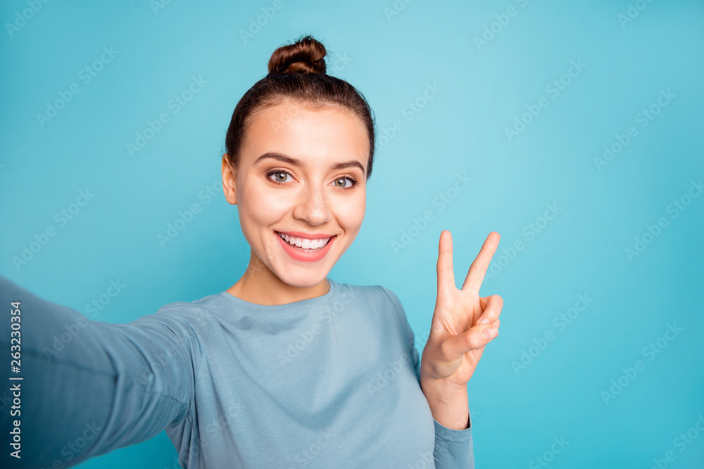 Self-portrait of her she nice-looking attractive winsome sweet lovable lovely cheerful cheery optimistic girl showing v-sign isolated over bright vivid shine turquoise background Self-portrait of her she nice-looking attractive winsome sweet lovable lovely cheerful cheery optimistic girl showing v-sign isolated over bright vivid shine turquoise background