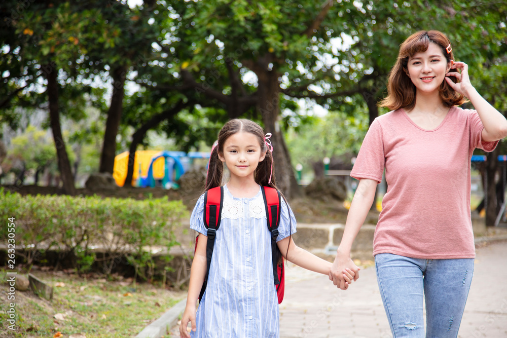 Mother and child holding hands going to school Mother and child holding hands going to school