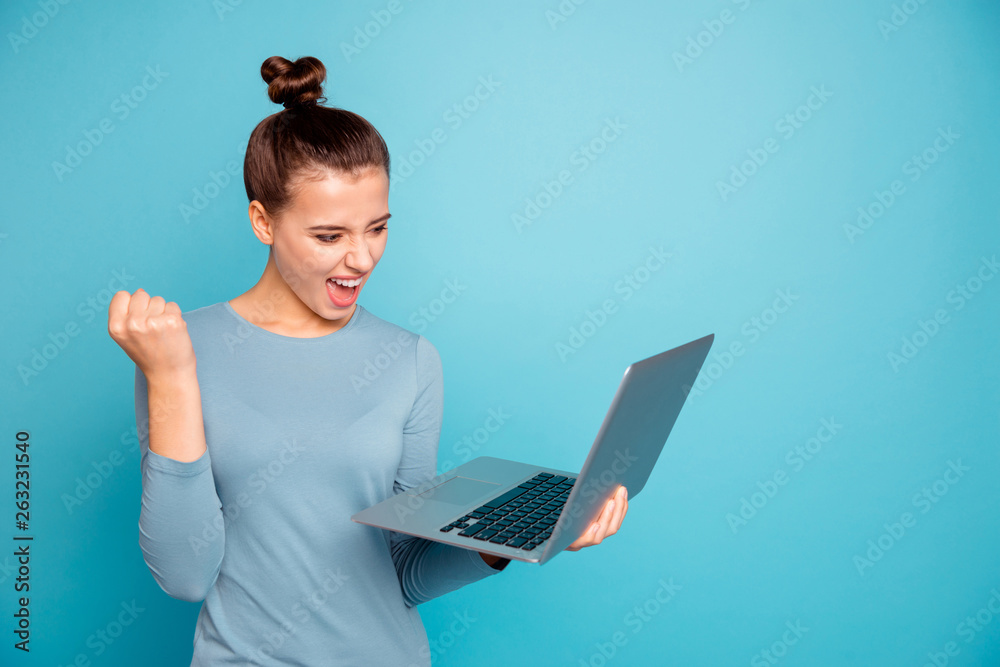 Portrait of positive excited lady raise fists hands scream get aim lottery shout yeah stylish successful modern technology use user dressed fashionable sweater smm isolated on blue background Portrait of positive excited lady raise fists hands scream get aim lottery shout yeah stylish successful modern technology use user dressed fashionable sweater smm isolated on blue background