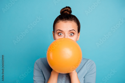 Close up photo of astonished funky teen teenager impressed omg wow unbelievable unexpected incredible wonder hide orange ballon hold hand wear modern pretty clothing isolated on blue background photo