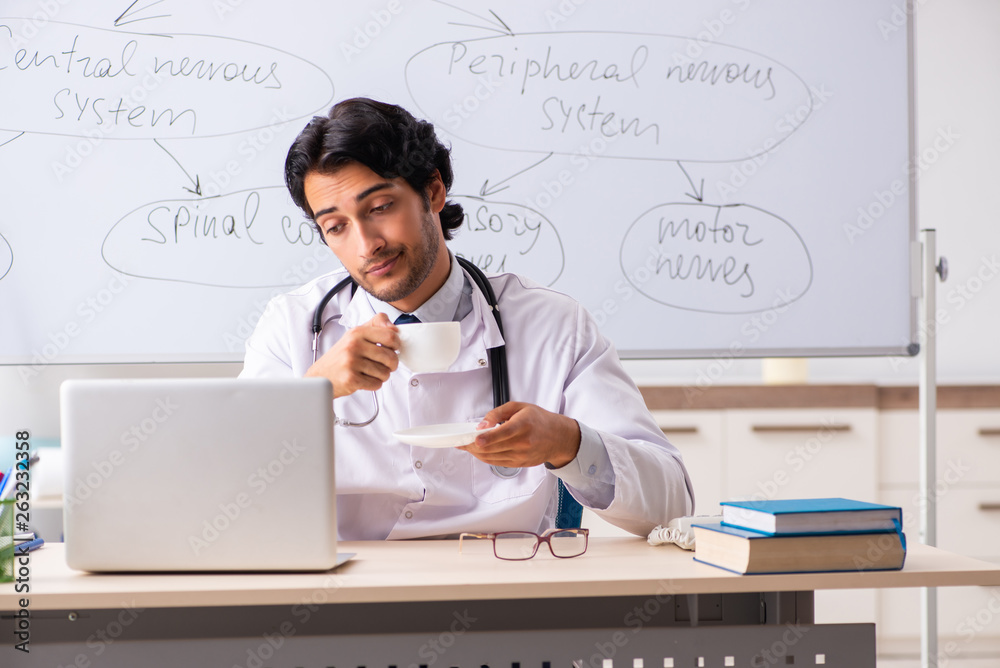 Young male doctor neurologist in front of whiteboard Young male doctor neurologist in front of whiteboard