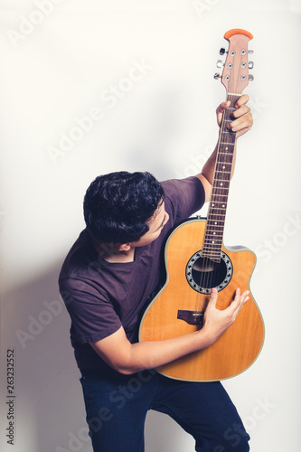 man playing guitar acoustic wearing t-shirt close up shot on white background