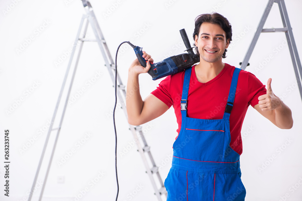 Young handsome contractor working indoors Young handsome contractor working indoors