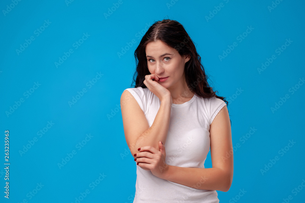 Thoughtful attractive young woman thinking on blue background Thoughtful attractive young woman thinking on blue background