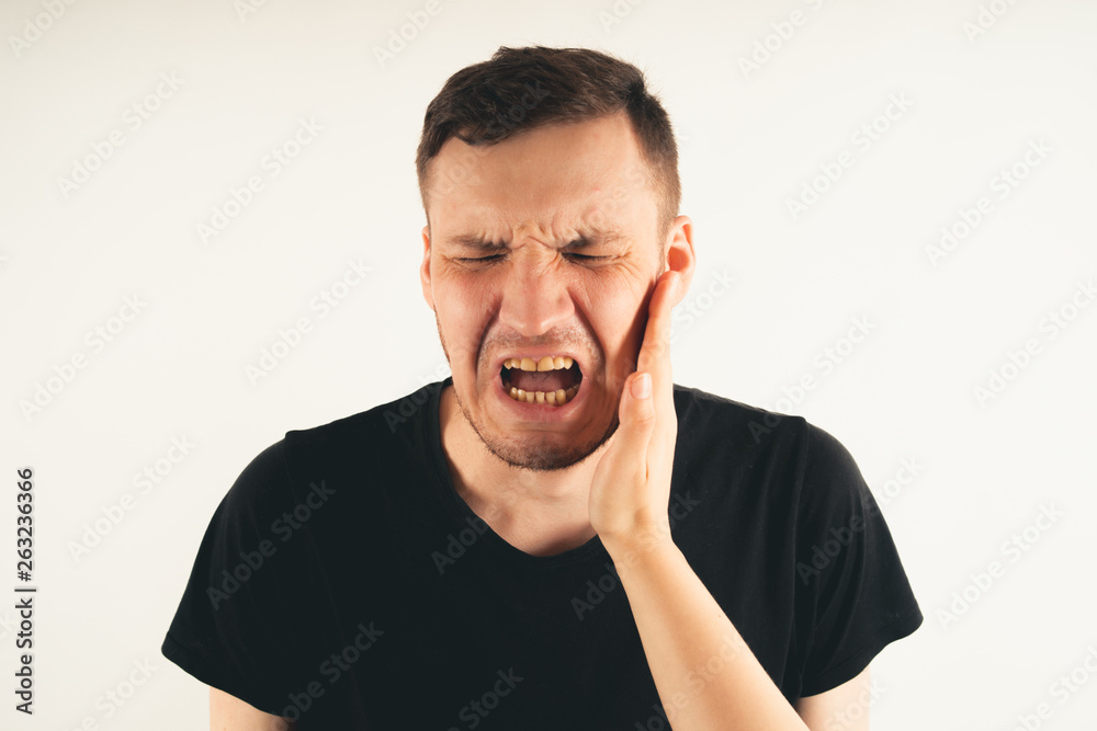 Crop person slapping scared man in face. Emotional male getting slapped in face while shouting with closed eyes in fear on white background