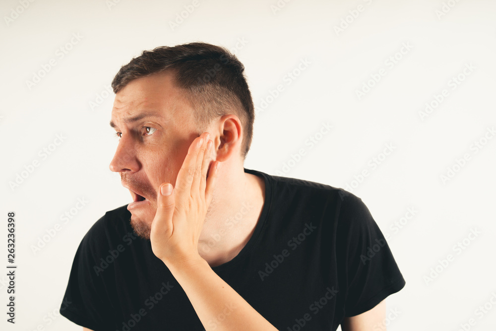Crop person slapping scared man in face. Emotional male getting slapped in face while shouting with closed eyes in fear on white background Crop person slapping scared man in face. Emotional male getting slapped in face while shouting with closed eyes in fear on white background