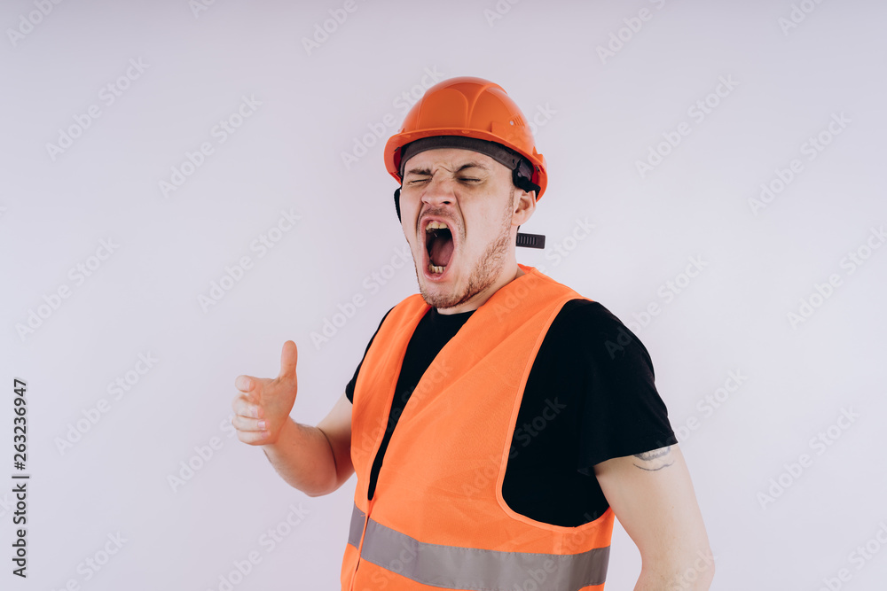 Man in working uniform on white background Portrait of young male in bright orange protective hardhat and vest looking at camera on white background Man in working uniform on white background Portrait of young male in bright orange protective hardhat and vest looking at camera on white background