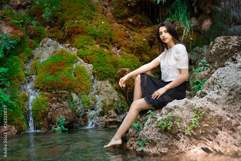 Beautiful dark haired girl posing in river with green plants. Beauty, fashion. Spa, healthcare. Tropical vacation. Natural pool. Beautiful dark haired girl posing in river with green plants. Beauty, fashion. Spa, healthcare. Tropical vacation. Natural pool.
