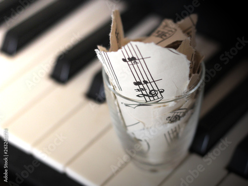 Принти на полотні Torn musical notes, pieces of paper on piano