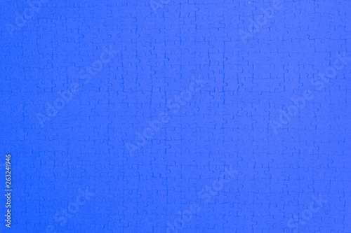 mosaic bright colored background from a puzzle, deep blue tone © BUSLIQ