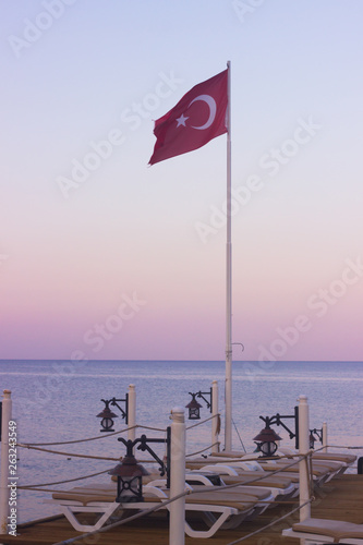 Fototapeta Naklejka Na Ścianę i Meble -  View on the sea bay and flag. Kemer, Turkey. Antalya coast