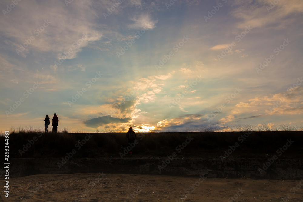 A beautiful sunset over the dunes. With silhouettes. Black Sea, Pomorie, Bulgaria.