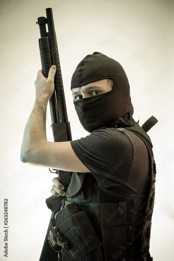 Thief, man armed with shotgun and bulletproof vest Thief, man armed with shotgun and bulletproof vest