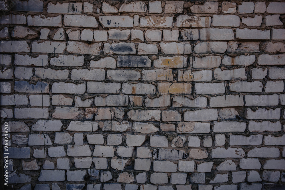 Background of old vintage dirty brick wall with peeling plaster, texture