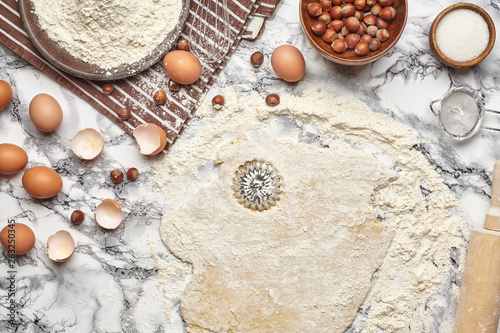 Close-up shot. Top view of a baking ingredients and kitchenware on the marble table background.