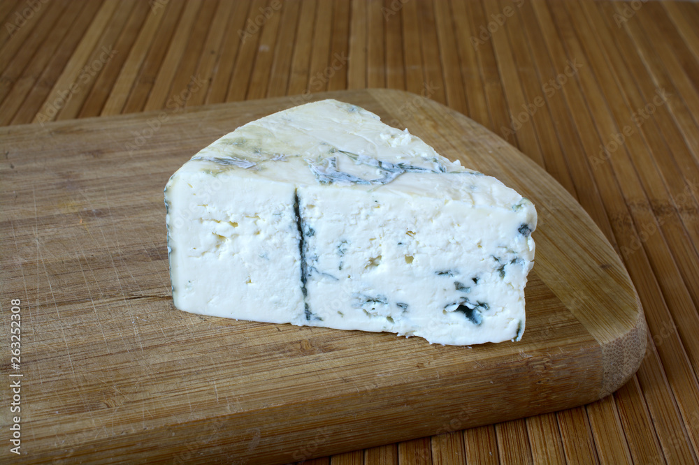 Blue cheese on a wooden board. Blue cheese on a wooden board.