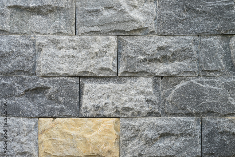 Fototapeta premium Grey granite or marble texture surface, has the yellow piece as different one. Pattern background. photo.