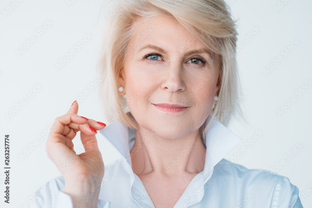 Aged self assured female portrait. Confidence and elegance. Stylish senior lady looking at camera. Index finger up. Aged self assured female portrait. Confidence and elegance. Stylish senior lady looking at camera. Index finger up.