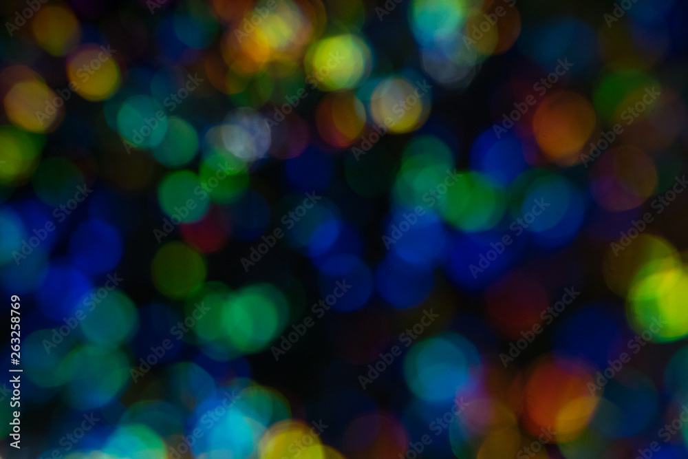 Defocused night city lights. Multiple colorful lens flare spots background. Defocused night city lights. Multiple colorful lens flare spots background.