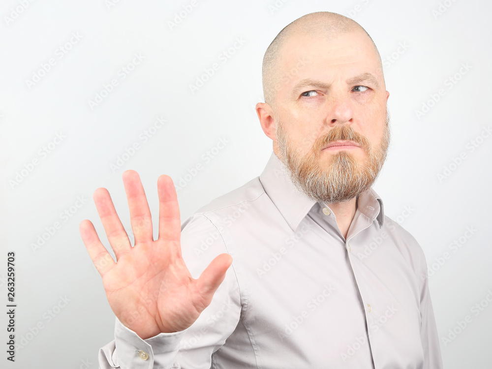 Bearded man in a shirt with a displeased facial expression and negative emotions Bearded man in a shirt with a displeased facial expression and negative emotions