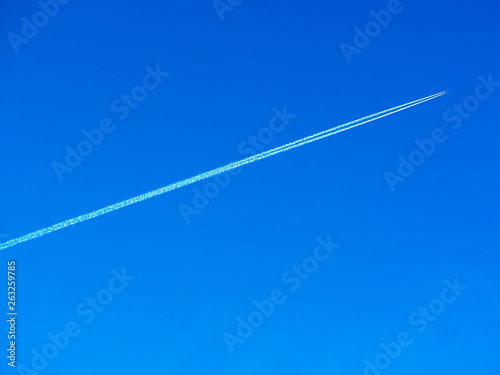 Diagonal trace from jet airplane in the clear sky background