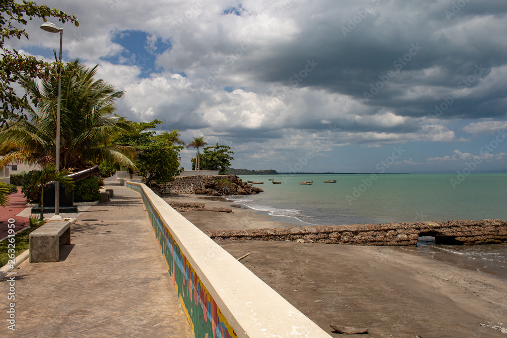Scenic view of the MIches bay in the Dominican Republic; green sea, boats, clouds.