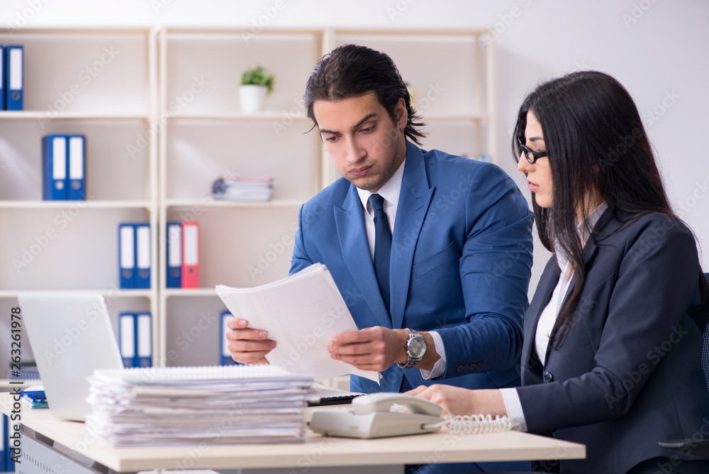 Two employees working in the office Two employees working in the office