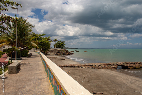Fototapeta Naklejka Na Ścianę i Meble -  Scenic view of the MIches bay in the Dominican Republic; green sea, boats, clouds.