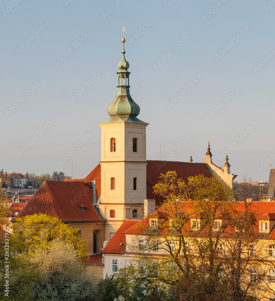 Sunset view of Church of Our Lady Victorious from Petrin Hill with blue sky.