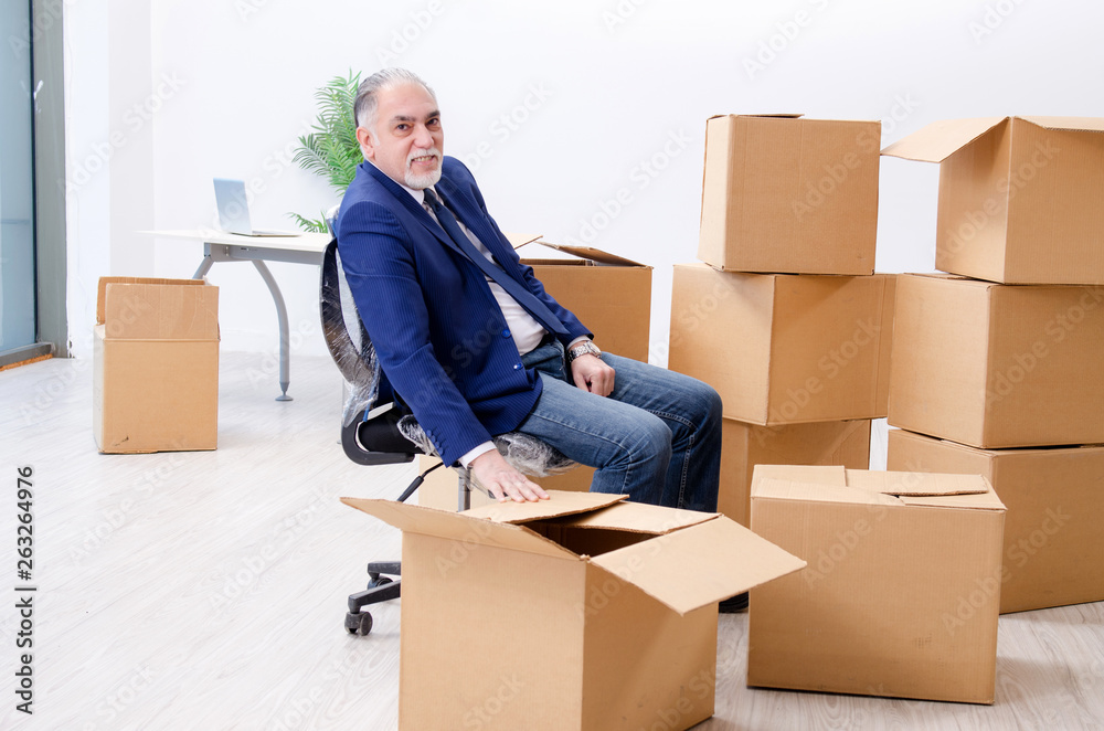 Aged businessman moving to new workplace Aged businessman moving to new workplace
