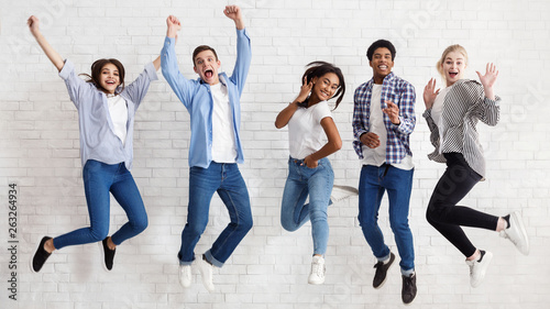 Happy students jumping on white background, passed exams