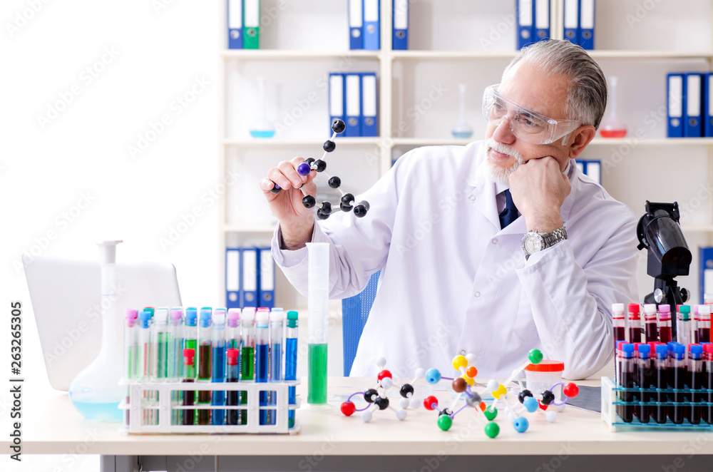 Old male chemist working in the lab Old male chemist working in the lab