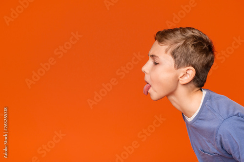 Photography Little boy teasing someone, showing tongue and making face