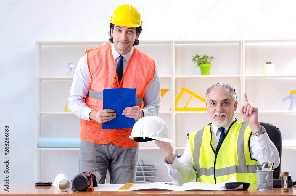 Two engineers colleagues working under project Two engineers colleagues working under project