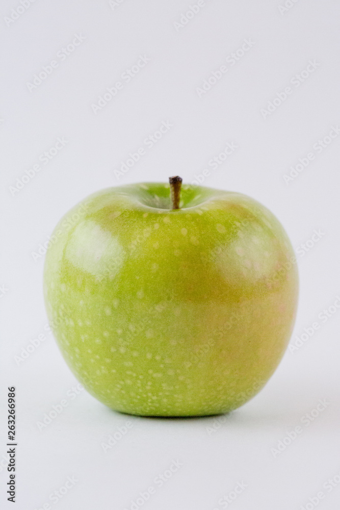 One single whole green apple isolated on white background One single whole green apple isolated on white background