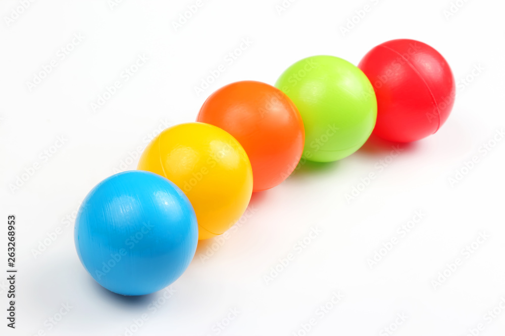Colored plastic balls on white background
