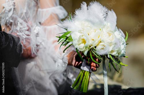 wedding bouquet in hands of bride