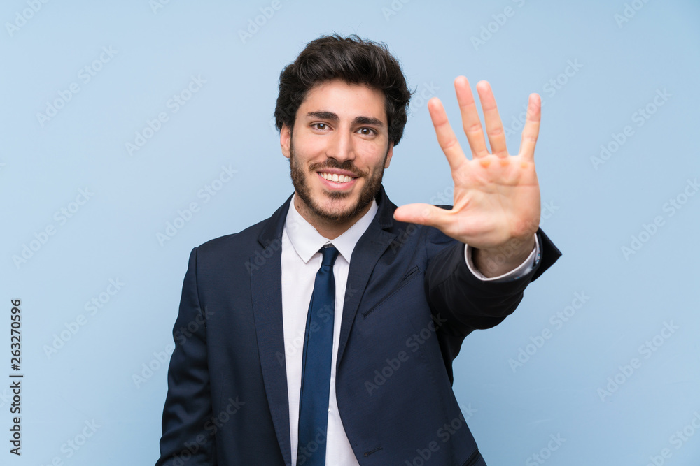 Businessman over isolated blue wall counting five with fingers Businessman over isolated blue wall counting five with fingers