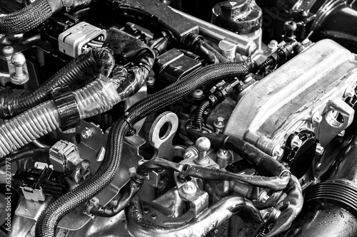Car engine. Car engine part. Close-up image of an internal combustion engine. Engine detailing in a new car. Car detailing. Black and white