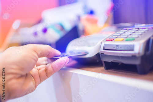 Hand put credit card In slot of credit card reader, credit card payment