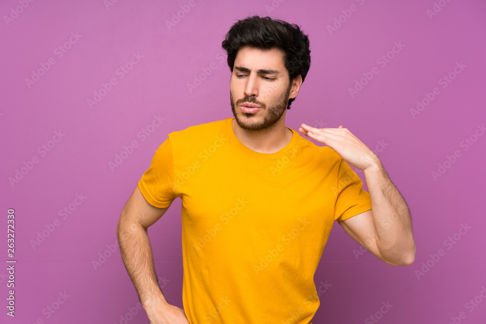 Handsome over isolated purple wall with tired and sick expression Handsome over isolated purple wall with tired and sick expression